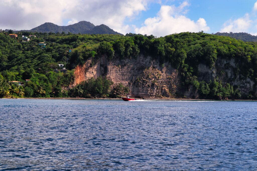 Speedboat tour cruising along St Lucia's west coast past jungle-covered cliffs