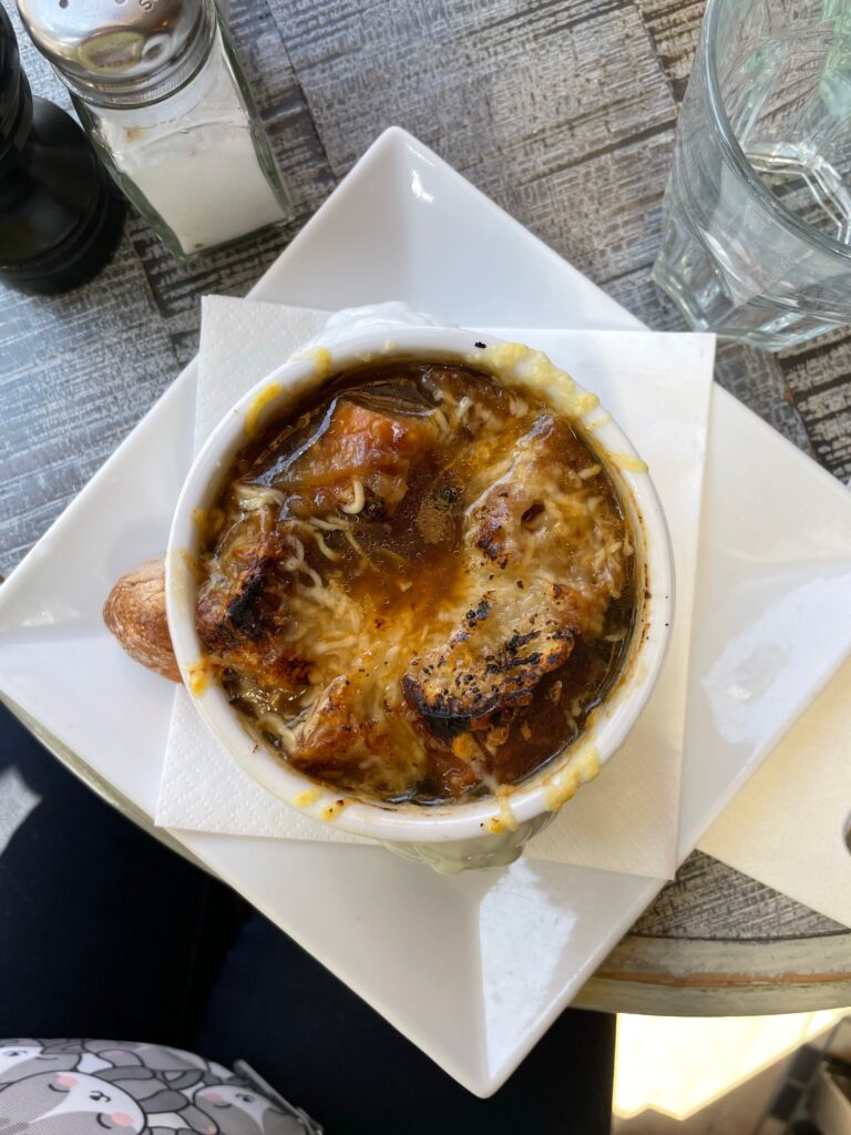 A bowl of French onion soup topped with broiled melted cheese and toasted bread, like the made-from-scratch soup served at Cafe Jacqueline in San Francisco